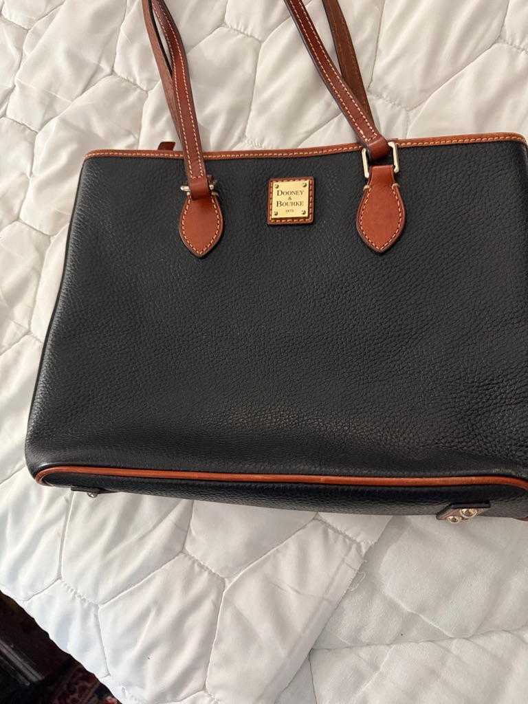Dooney & Bourke Black Pebbled Leather Tote With Brown Trim And Gold Plaque